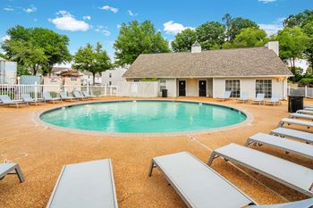 the resort style pool is heated and has seating around it